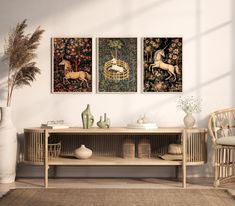 two paintings hang on the wall above a wooden table with vases and other items