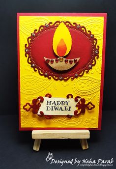 a happy diwali card with a lit candle on it