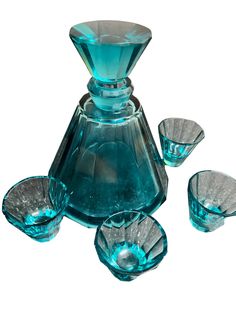 an assortment of blue glass items on a white background