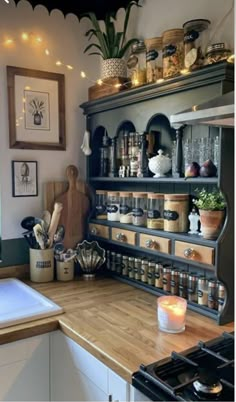 a kitchen with lots of pots and pans on the shelves