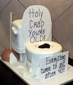 a toilet cake that has been made to look like it is holding a roll of toilet paper