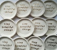 many white plates with words on them that say tiny, beautiful things and tiny beautiful things