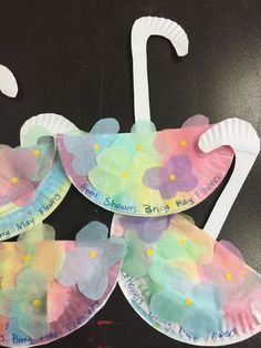 three paper plates with flowers on them and the names of each child's name