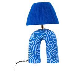 a blue and white lamp sitting on top of a table