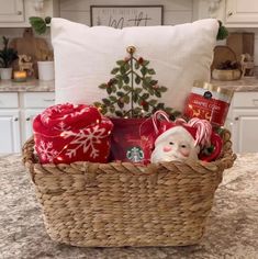 a basket filled with christmas items sitting on top of a counter next to a pillow