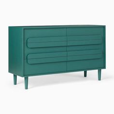 a green dresser with four drawers and three legs