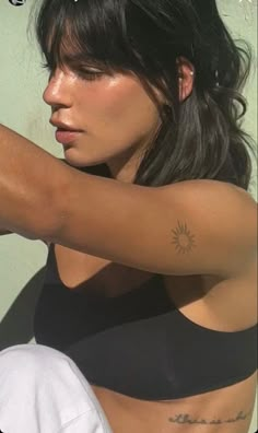 a woman with a tattoo on her arm