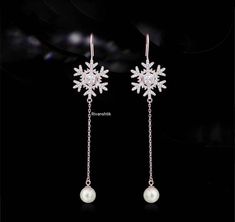 Handmade Earrings The delicate sparkle of Sterling Silver is enhanced by dazzling Cubic Zirconia in these Dangler is exquisite! These Snowflake Earring are made from Sterling Silver and Cubic Zirconia and a Single Pearl. Gives you a luxury quality at a affordable price. Whether its a birthday, holiday, a special occasion, or just because, jewelry is always the perfect gift for Christmas, Anniversary, Mothers Day, Valentines Day, or birthday. Diamond Wt. -- 1:05ct Diamonds- American diamonds Diam Elegant Snowflake Jewelry For Party, Elegant White Christmas Earrings, Elegant Snowflake Earrings For Parties, Elegant Snowflake Jewelry For Festive Occasion, Elegant Snowflake Earrings For Anniversary, Elegant Snowflake Jewelry For Wedding, White Snowflake Wedding Earrings, Elegant White Snowflake Earrings, Elegant Christmas Earrings