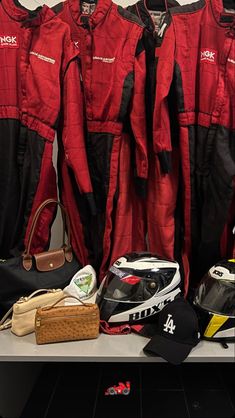 several red and black jackets hanging on a wall