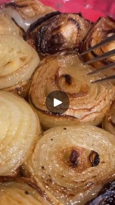 onions being cooked with tongs in a bowl