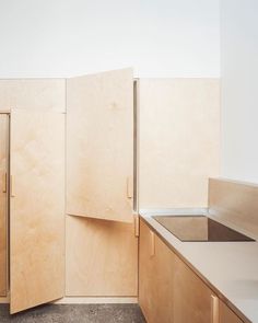 an unfinished kitchen with wooden cabinets and counter tops