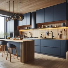 a modern kitchen with blue cabinets and wooden flooring is pictured in this image, there are two bar stools at the center of the island