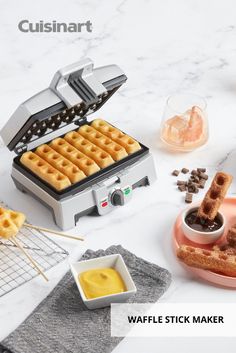 the waffle stick maker is on display with other food items and utensils