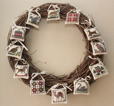 a wreath made out of twigs with pictures hanging on it