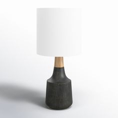 a black table lamp with a white shade on the base and a wooden stick sticking out of it