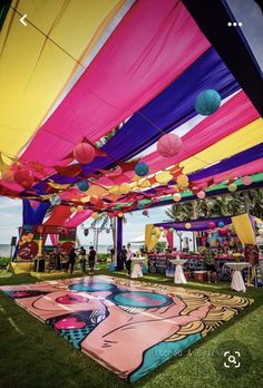 an outdoor event with colorful decorations and tables