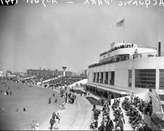 an old black and white photo of people on motorcycles in front of a large building