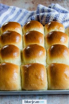 a pan filled with rolls sitting on top of a table