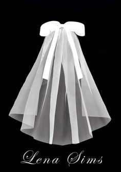 a dress made out of white paper with a bow on the front and back side