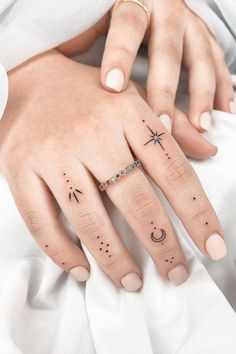 a woman's hand with tattoos on it and a star, moon and crescent