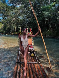 a woman sitting on top of a bamboo raft