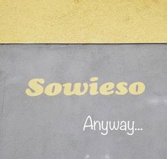 a yellow and gray sign that says soweiso on the side of a building