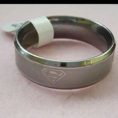 Men's Stainless Steal Ring With Superman Logos. High Quality Stainless Steel 8mm Ring With Superman Logos All Around The Ring In Size 14. 316 Stainless Steel Sliver Tone 5mm Logos Color, Mens Stainless Steel Rings, Superman Logo, Stainless Steal, Stainless Steel Ring, Mens Accessories Jewelry, Stainless Steel Rings, Steel Ring, Logo Color