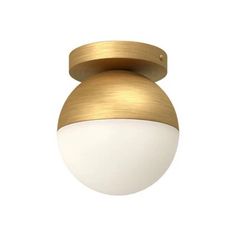 a white and gold light fixture on a white wall with a round glass ball in the center