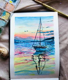 a watercolor painting of a sailboat in the ocean at sunset with paintbrushes nearby