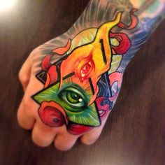 a person's hand with a colorful tattoo on it