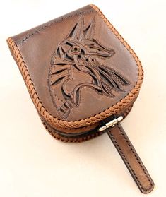 a brown leather case with an image of a cat on it