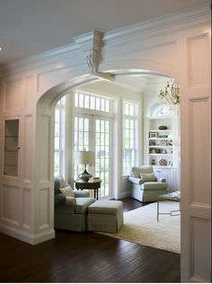 a living room filled with furniture and a chandelier