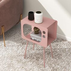 a pink end table with a magazine rack on it