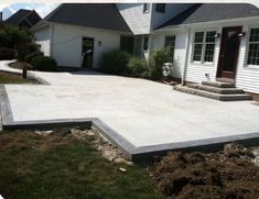 a concrete patio being built in front of a house