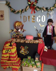 a table that has some food on it with decorations around it and a person standing next to the table