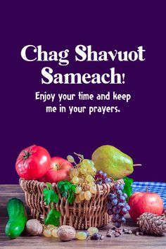 a basket filled with fruit and vegetables on top of a wooden table next to a purple background