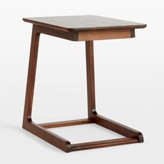 the side table is made out of wood and has a square shaped base with an open end