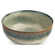 a green and brown bowl sitting on top of a white table