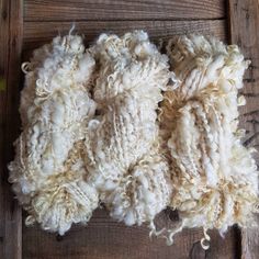 a pile of wool sitting on top of a wooden floor