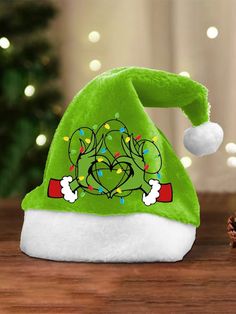 a green christmas hat sitting on top of a wooden table