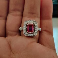 Beautifull Vintage & Art Deco Ring,2.00CT Emerald Cut Red Garnet Gemstone Ring,Halo Lab Diamond Ring,Best quality Silver ring. ▶ PRODUCT DETAILS ✦ Diamond Shape : Emerald cut ✦ Setting Type : Prong ✦ Metal Purity - 925 silver ✦ Color: Red garnet ▶ Accent Stones : * Color : White * Clarity: VVS * Shape : Round Moissanite Do mention it in the personalization section or concern with us by dropping a message. All Products of the shop will be customized with metal purity like 10K Solid Gold, 14K Solid Gold and 18K Solid Gold. Also It will be customized with Natural Diamond, Lab Grown (CVD - HPHT) Diamond, Natural Black Diamond, Natural Gemstone and Moissanites. If you have any additional questions about this ring, just hit the "Ask a Question" button (just to the right of the price) and we will Diamond Ruby Ring With Stone Setting As A Gift, Red Diamond Jewelry With Halo Design, Gift Ruby Ring With Diamond Stone Setting, Gift Diamond Ruby Ring With Stone Setting, Gift Ruby Ring With Diamond Setting, Emerald Cut Hallmarked Ruby Ring For Gift, Emerald Cut Red Ring For Gift, Red Emerald Cut Rings With Accent Stones, Red Emerald-cut Ring For Gift