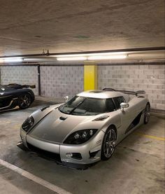 two cars parked in a parking garage next to each other