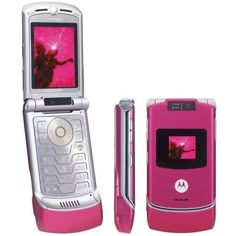 a pink motorola cell phone sitting next to an open smart phone with the image of a woman on it