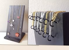 there are many necklaces on display in the holder, and one is hanging from the wall