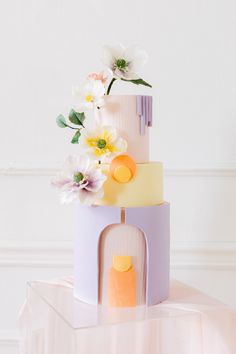 a three tiered cake with flowers on top