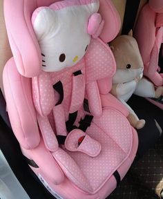 a hello kitty baby car seat with stuffed animals in the back and side facings