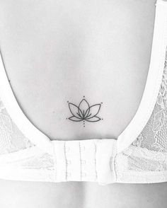 a lotus tattoo on the back of a woman's stomach