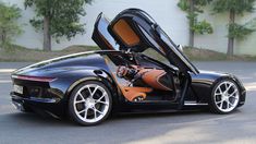 a black sports car with its doors open