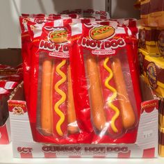 hotdogs wrapped in plastic are on display