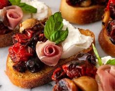 some breads with toppings on them are sitting on a marble table and the title reads, deliciously seasoned tomato bruschetta with burrata